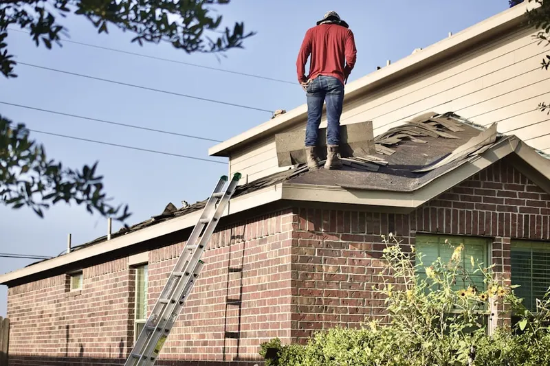 Professional roofer working on a residential roof in Montross